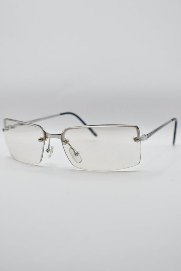 Silver-rimmed glasses on a light gray background