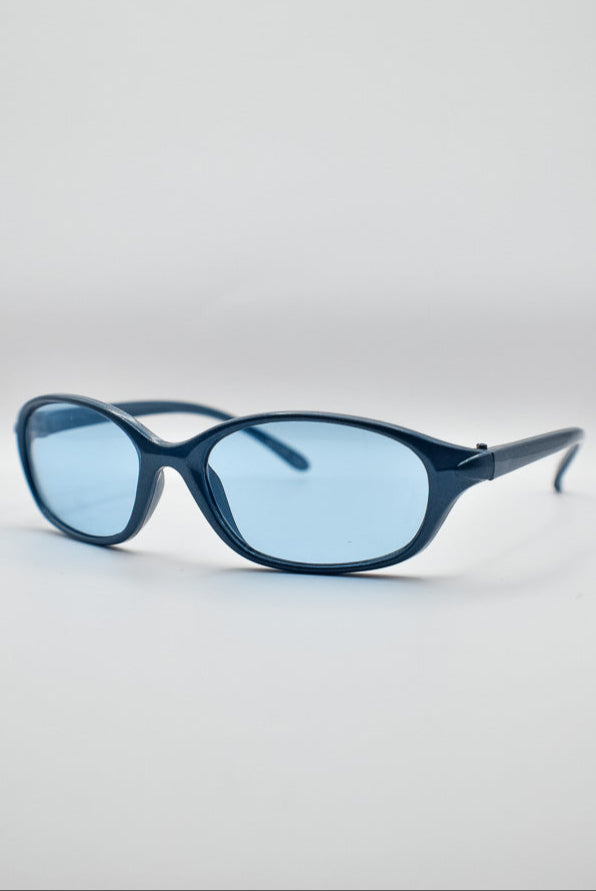 Blue sunglasses on a light gray background