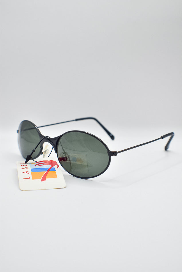 Sunglasses with a tag on a light gray background