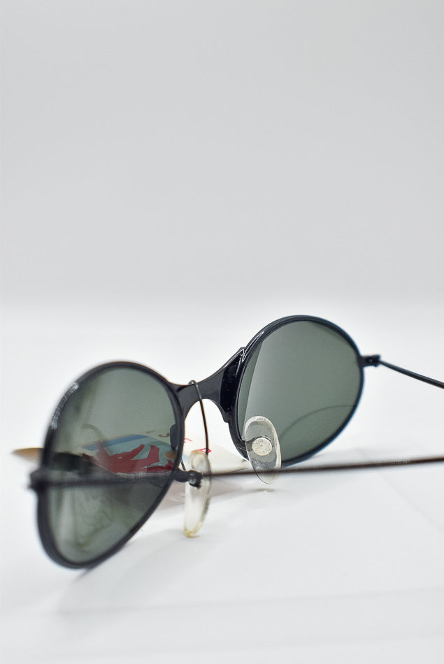 Round sunglasses with dark lenses on a white background