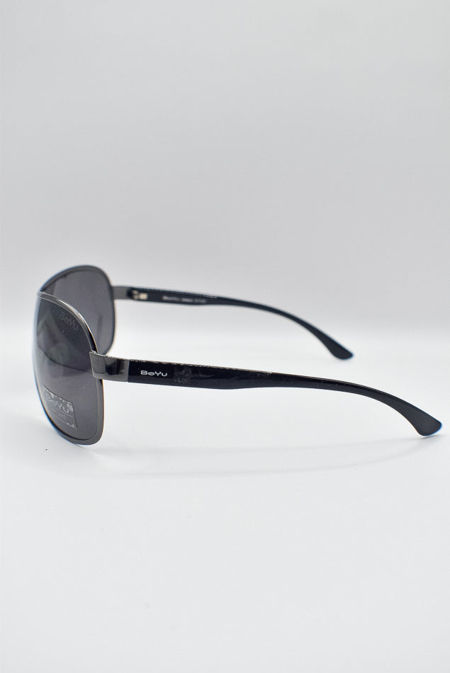 Black sunglasses with reflective lenses on a light gray background
