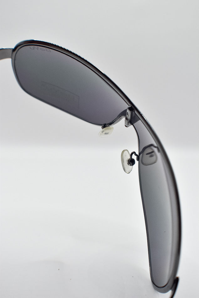 Sunglasses with dark lenses on a light gray background