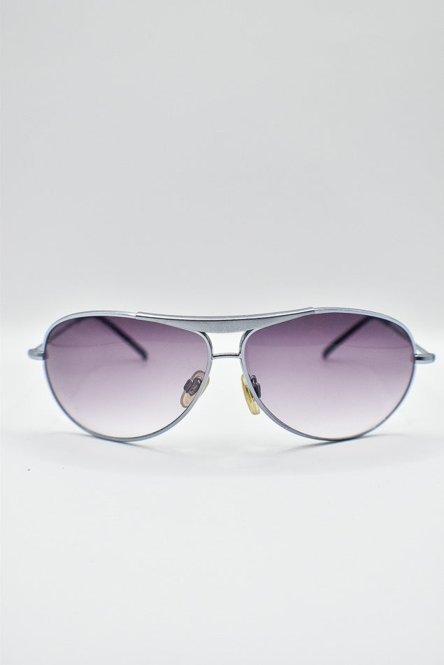 Aviator sunglasses with purple gradient lenses on a white background