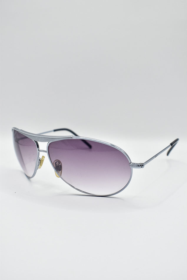 Silver sunglasses with purple lenses on a white background