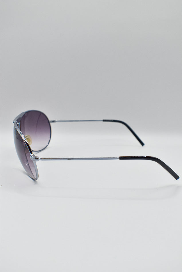 Aviator sunglasses with purple lenses on a light gray background