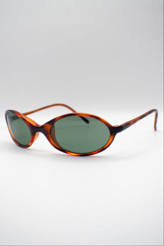 Sunglasses with tortoiseshell frame and dark lenses on a light gray background