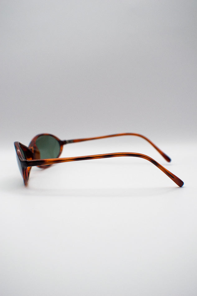 Sunglasses with tortoiseshell frame on a light gray background