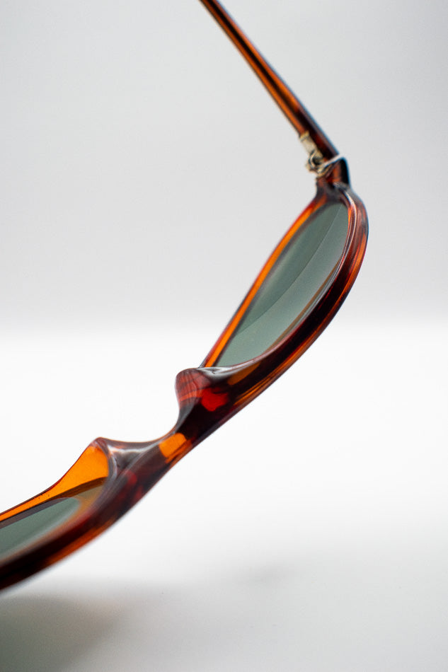 Close-up of a tortoiseshell sunglasses with a blurred background