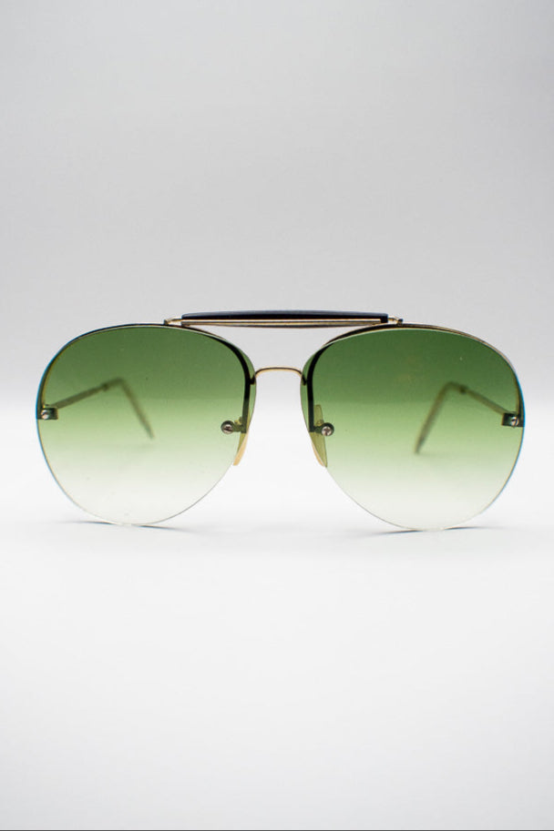 Aviator sunglasses with green gradient lenses on a white background